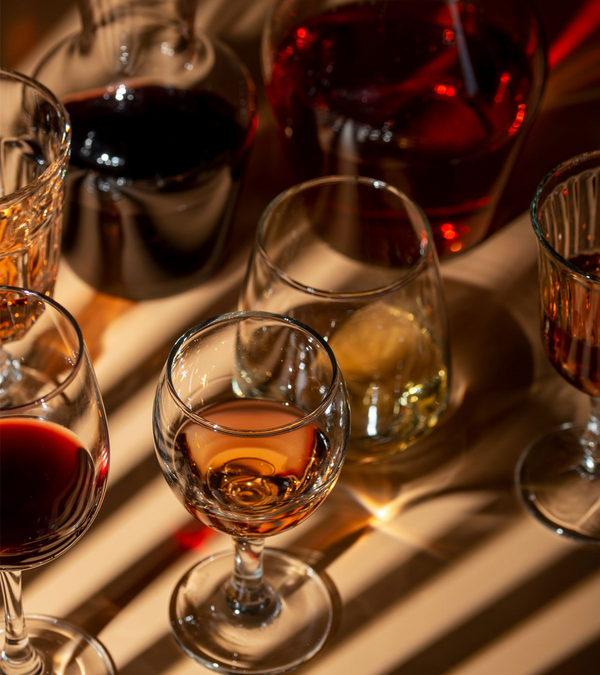 A wine bottle and glass on a dinner table