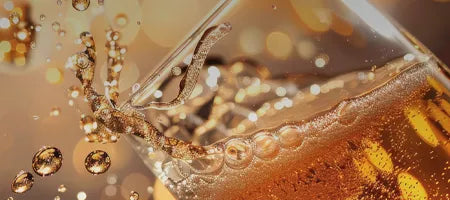 Close-up of a glass with a sparking portuguese wine and ice cubes, with a blurred background