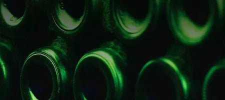 Close-up of vinho verde green bottles stacked together