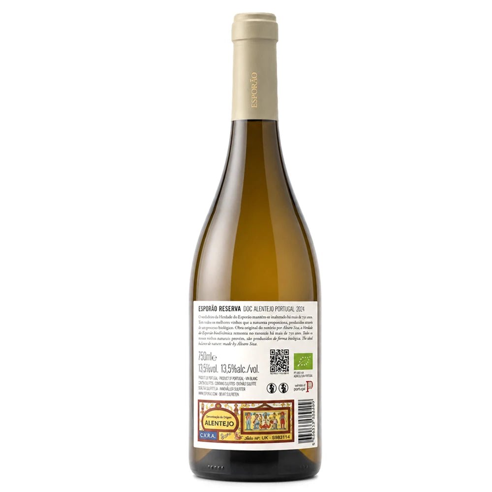 A bottle of Esporão Reserva DOC Alentejo white wine, shown from the back against a plain white background. The bottle is made of dark glass, revealing the pale yellow wine inside, and features a beige foil capsule and a detailed white label with various certification logos.