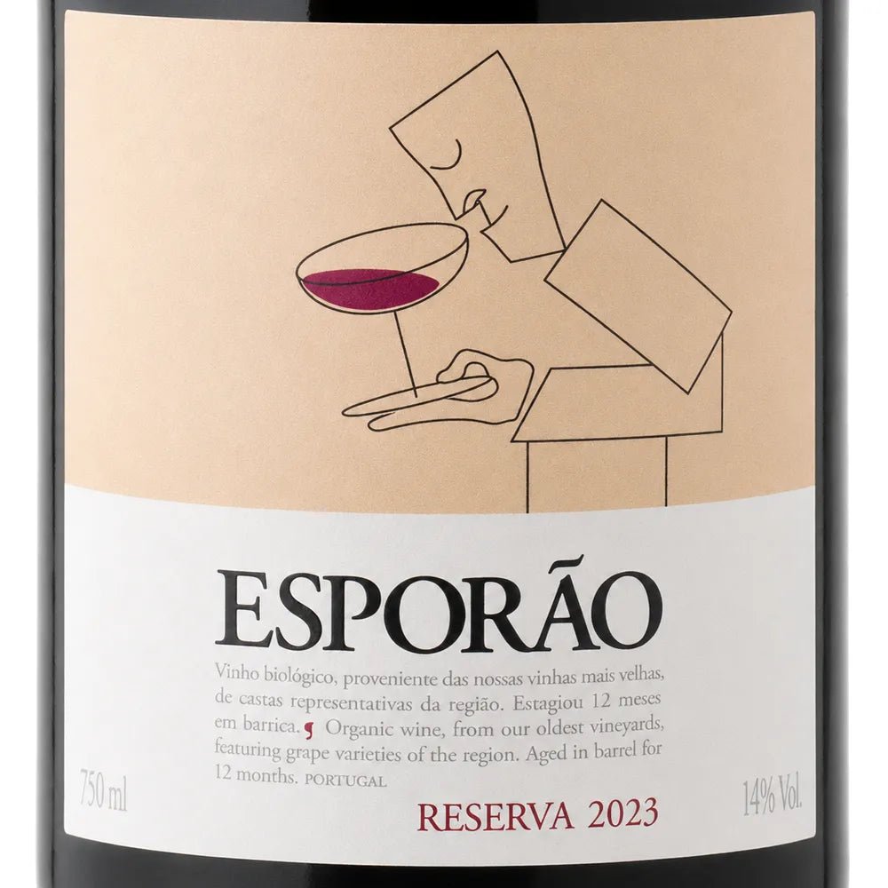 A close-up of a wine bottle label for Esporão Reserva 2023. The label has a warm beige upper section with a minimalist line drawing of a person holding a glass of red wine, and a white lower section with black and red text.