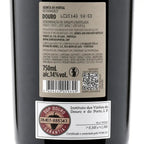 Close-up of a dark bottle label showing Portuguese text for Douro red wine, including a large product info sticker and a smaller Sop Douro guarantee sticker.