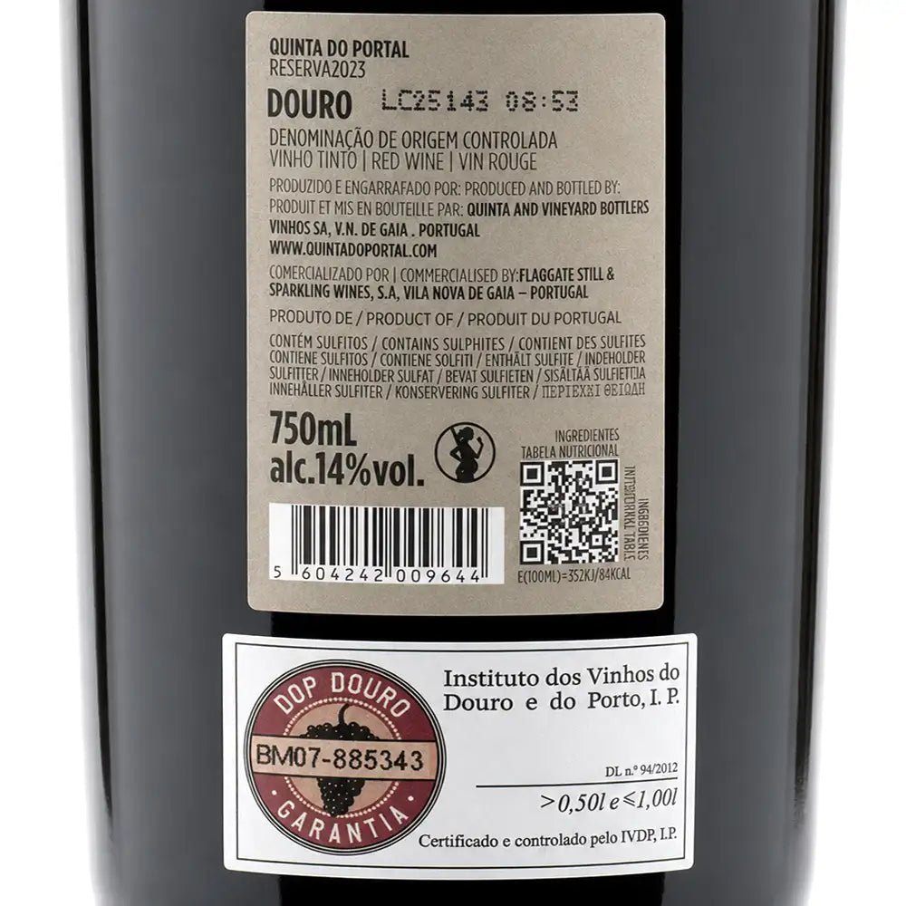 Close-up of a dark bottle label showing Portuguese text for Douro red wine, including a large product info sticker and a smaller Sop Douro guarantee sticker.