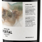 Close-up of a wine bottle label reading Quinta do Portal Douro Valley Portugal, with a large white label featuring a painted landscape and Portuguese text.