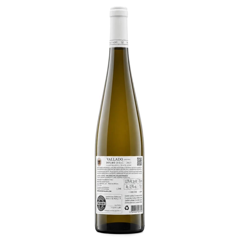 A tall glass bottle of Vallado-Prima white wine shown from the back, featuring a white screw cap, a dark olive-green glass body, and a detailed white product label with text and a QR code.