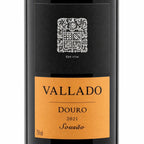 Front view of a Vallado Sousão Douro 2021 Sousão wine bottle, showing a black label with a silver crest and a warm orange label below.