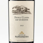A close-up of a wine bottle label for Quinta Da Romaneira Dona Clara IGP Duriense 2021, featuring a beige label with a black illustration of a vineyard estate and a small gold crest.