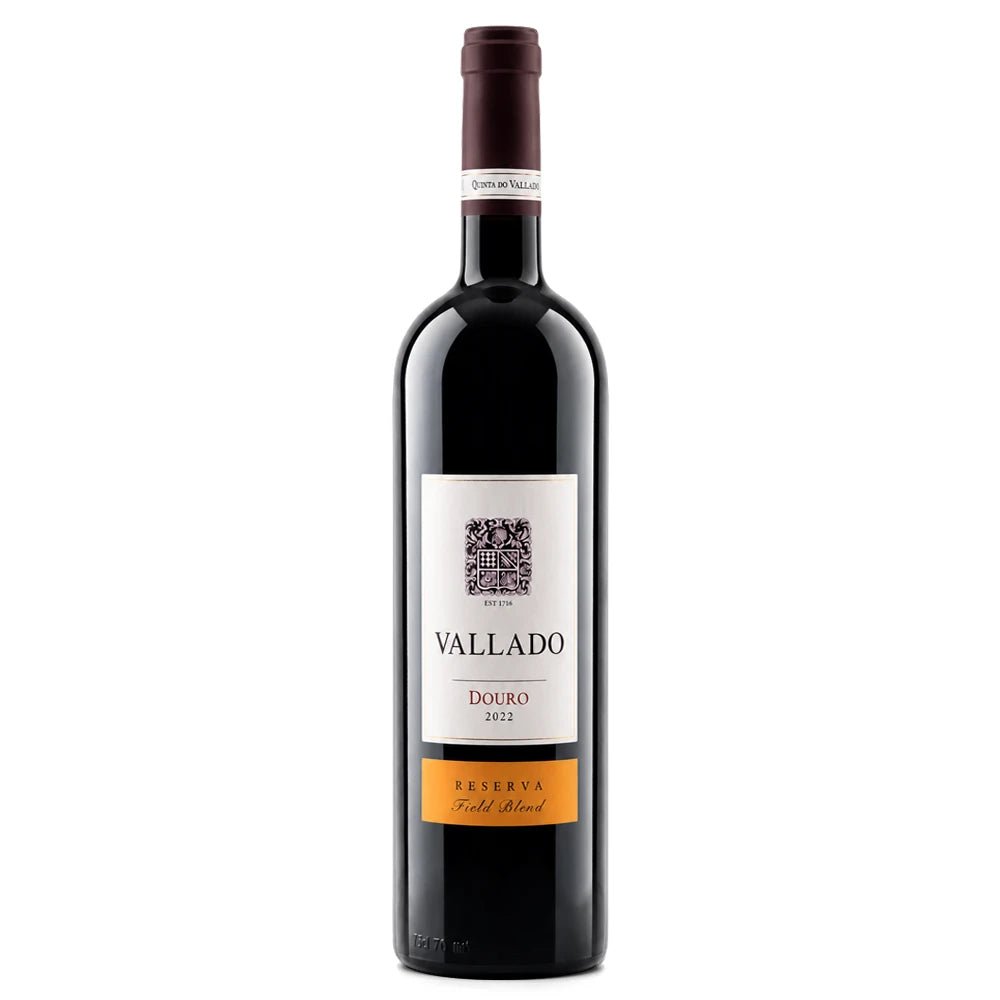 A bottle of Vallado Douro 2021 Reserva Field Blend red wine, featuring a dark glass bottle, a white label with black text, and an orange accent band at the bottom, set against a plain white background.