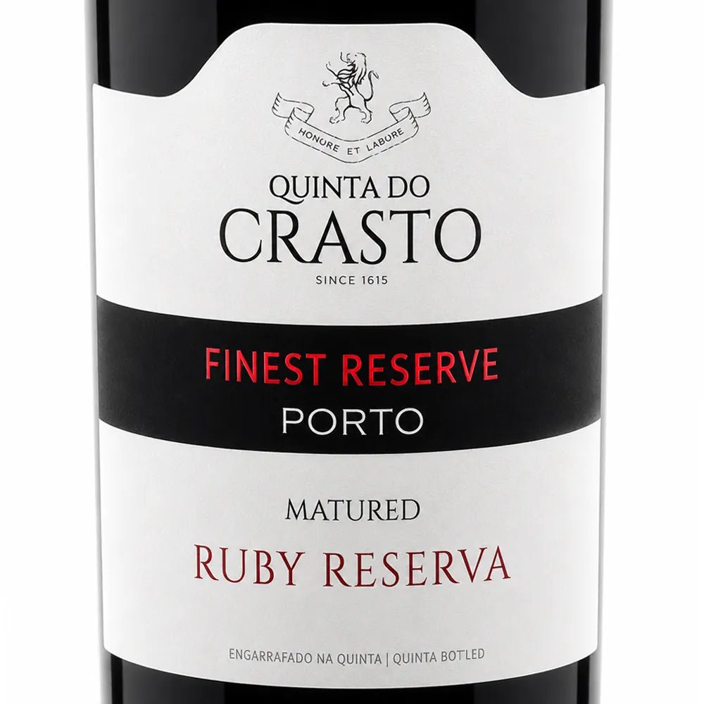 Close-up of a Quinta do Crasto wine bottle label, showing 'Finest Reserve Porto' and 'Matured Ruby Reserva' on a white and black label.