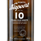 Close-up of a Niepoort 10 Years Old White Port wine bottle, showing the white label text against the dark amber glass.