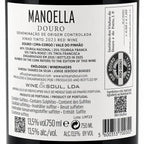 A close-up of a wine label reading MANOELLA DOURO, showing product details, wine type, producer information, barcode, and regulatory text on a white label.