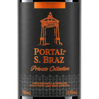 A close-up of a wine bottle label for Portal de S. Braz Private Collection, featuring a black background with orange text and illustration of a chapel on a cross.