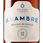 Close-up of a white decorative wine label reading 'ALAMBRE' and 'José Maria da Fonseca' on a dark amber bottle background.