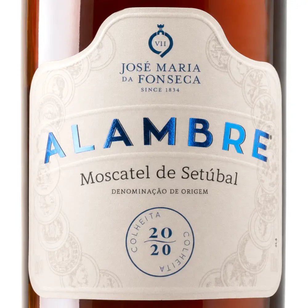 Close-up of a white decorative wine label reading 'ALAMBRE' and 'José Maria da Fonseca' on a dark amber bottle background.