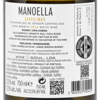 Close-up of a wine label reading MANOELLA DOURO, with Portuguese text, a barcode, QR code, and circular wine institute seal on a dark bottle background.