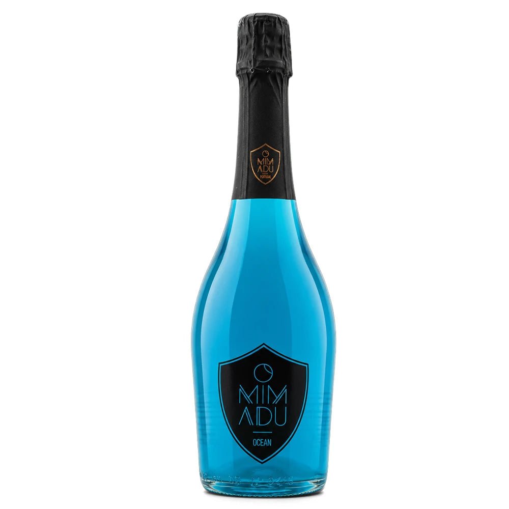 A bottle of Mimadu Ocean sparkling drink with vibrant blue liquid, a black foil neck, and a black shield logo on the front, set against a plain white background.