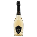 A bottle of Mimadu sparkling wine with a pale golden-amber liquid, a black foil capsule, and a black shield-shaped label on a plain white background.