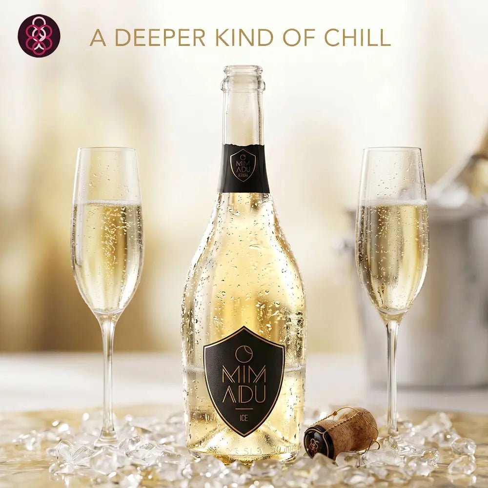 A bottle of Mimadu sparkling wine with two filled champagne flutes, ice, and a cork on a warm beige background with the text 'A DEEPER KIND OF CHILL' and a brand logo in the top left.