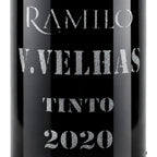 Close-up of a black wine bottle label with silver glitter-style text reading RAMIRO, V.VELHAS, TINTO, and 2020.