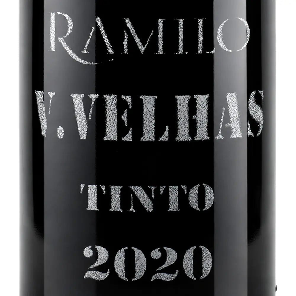 Close-up of a black wine bottle label with silver glitter-style text reading RAMIRO, V.VELHAS, TINTO, and 2020.