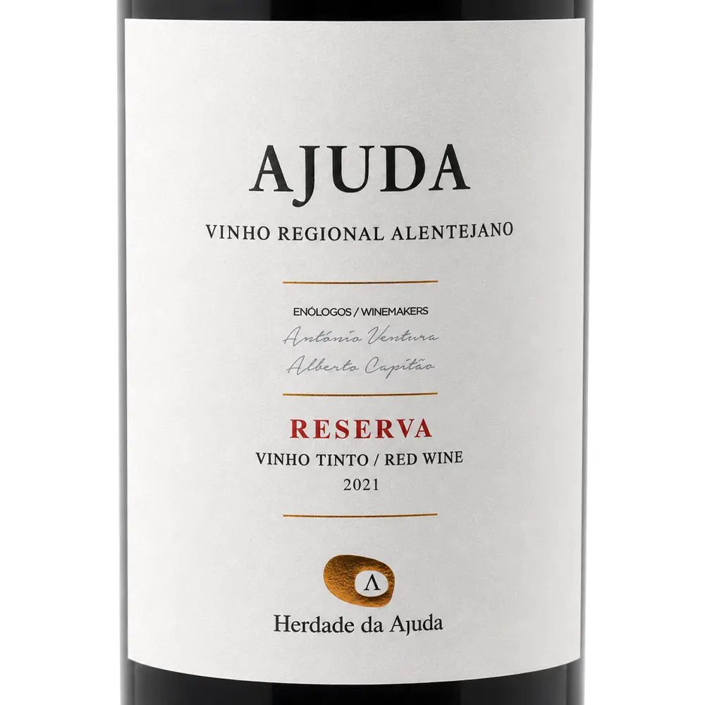 A close-up of a wine bottle label reading AJUDA Reserva Vinho Tinto Red Wine 2021, with a white label, black text, and a small gold seal on a dark bottle background.