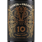 Close-up of a black wine label with ornate gold foil detailing and the text 'QUINTA DA VACARIA' and '10 TAWNY PORT'.