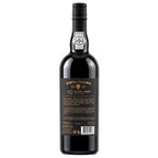 A bottle of Quinta da Vacaria 10 Year Old Tavoy Port wine, shown from the back against a plain white background. The bottle is made of very dark glass, appearing black, with a black screw cap and a black label featuring gold and white text.
