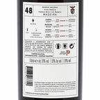 The back of a 750ml wine bottle showing the Portuguese label details for Reserva Malvasia Madeira. The label is white with black text and red accents, displaying wine style characteristics, production info, and a wine glass icon indicating it is a wine product.