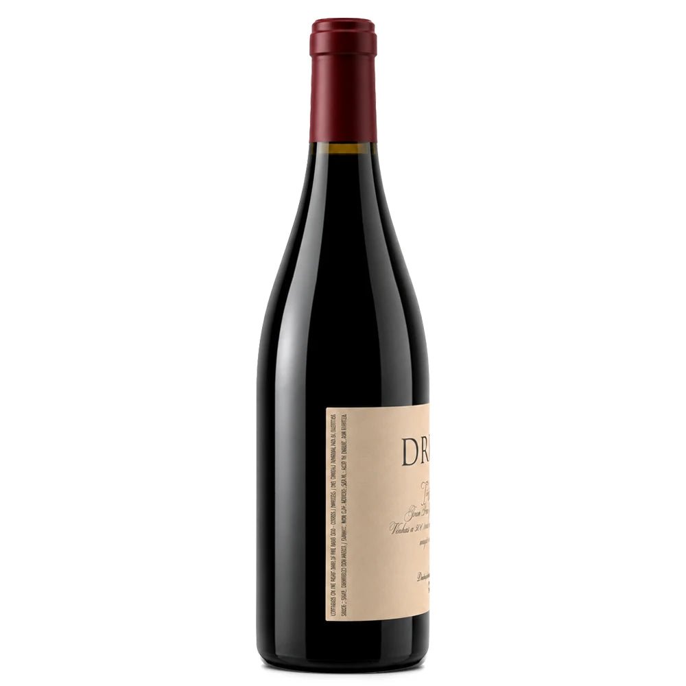 A bottle of red wine with a dark glass body, a beige label, and a dark red foil capsule, shown against a plain white background.