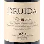 Close-up of a wine bottle label reading DRUIDA, with additional text including Tinto 2021 and Dão, plus Mira do ó branding at the bottom, on a light beige background.