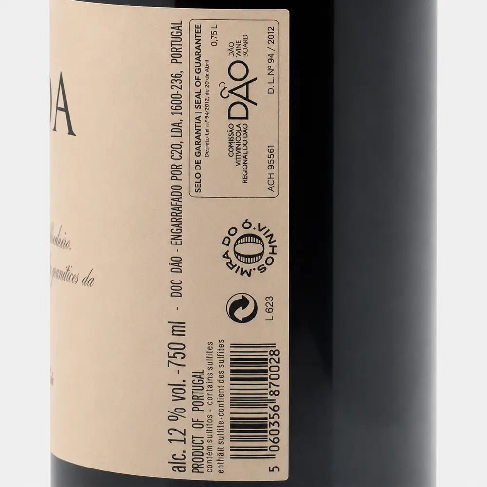 Close-up of a wine bottle label with the brand DRUIDA visible, showing part of the dark bottle and a cream-colored label with black text.