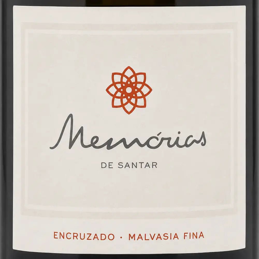 Close-up of a wine label reading 'Memórias de Santar' with an orange geometric flower logo and 'ENCRUZADO • MALVASIA FINA' at the bottom, shown against a dark bottle background.