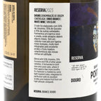 Close-up of a wine bottle label for Reserva 2023 Douro Denominação de Origem Controlada Vinho Branco, showing Portuguese text, a gold tax stamp, and part of the dark bottle.