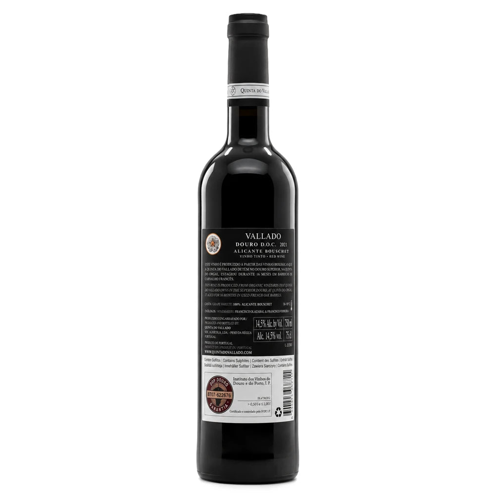 A bottle of Vallado-Alicante-Bouschetshown from the back, featuring a black label with white and gold text, a black screw cap, and a white barcode sticker near the bottom