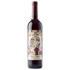 A bottle of Julia Florista red wine, featuring a detailed vintage-style label with an illustration of a woman in a red dress and a shop interior, set against a plain white background.