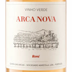 Close-up of a wine bottle label reading 'VINHO VERDE ARCA NOVA Rosé' with a black line drawing of a vineyard and buildings on an off-white background.