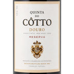 Front-facing wine bottle label for Quinta do Cotto Douro Reserva red wine, with a cream label, black and gold typography, and a decorative crest on a white background.