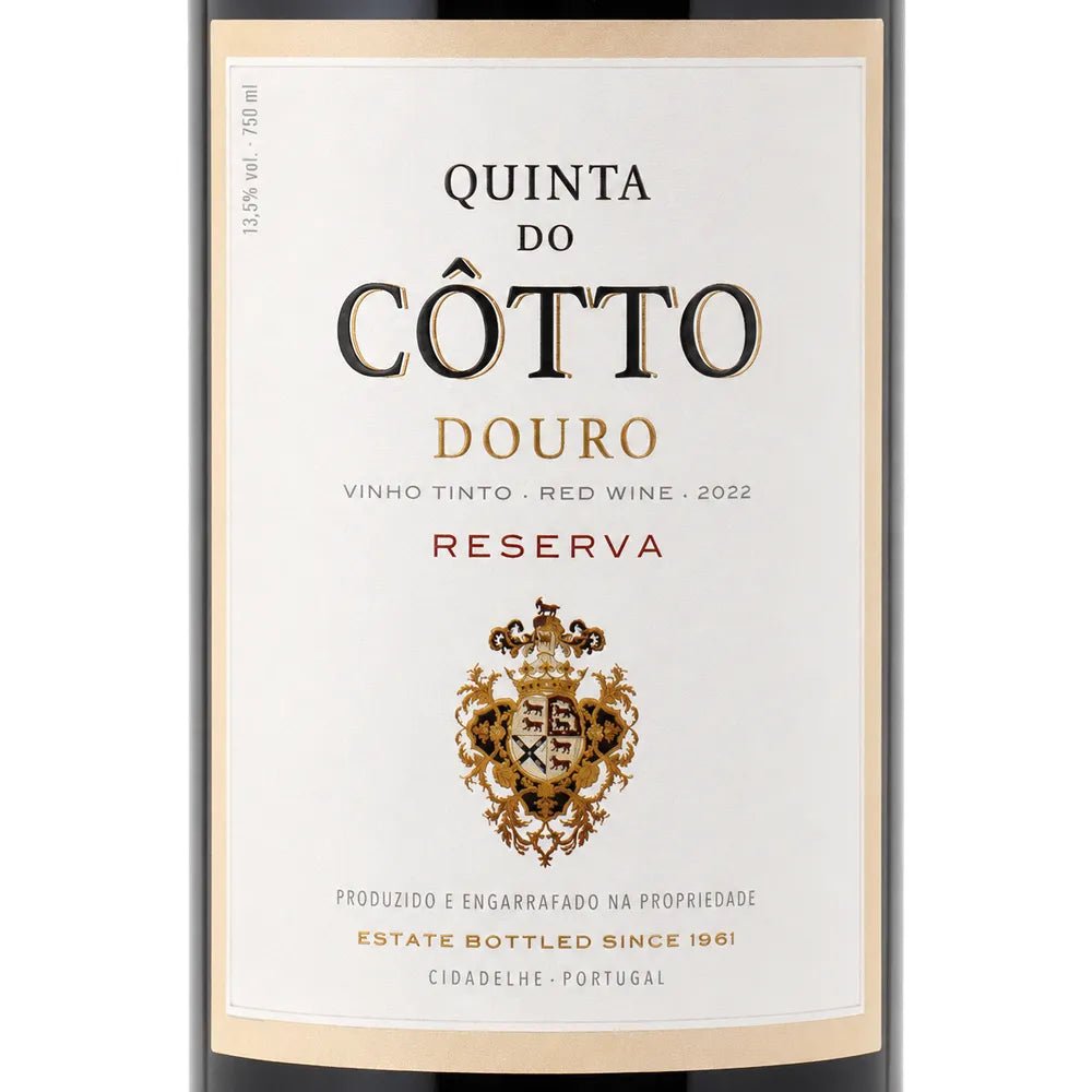 Front-facing wine bottle label for Quinta do Cotto Douro Reserva red wine, with a cream label, black and gold typography, and a decorative crest on a white background.