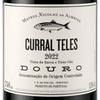 Close-up of a wine bottle label reading 'CURRAL TELES 2022' with a fish illustration and the brand name 'MATEUS NICOLAU DE ALMEIDA' above, on a white label with dark bottle edges visible at the top and bottom.