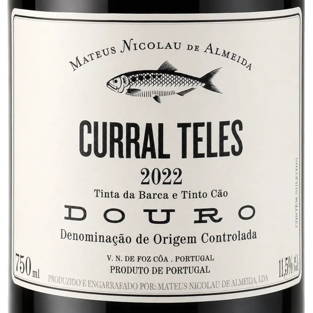 Close-up of a wine bottle label reading 'CURRAL TELES 2022' with a fish illustration and the brand name 'MATEUS NICOLAU DE ALMEIDA' above, on a white label with dark bottle edges visible at the top and bottom.