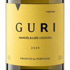 Close-up of a wine bottle label reading GURI, Manuel & Luis Cerdeira, 2025, with a mustard-yellow label and dark glass bottle visible at the top and bottom.
