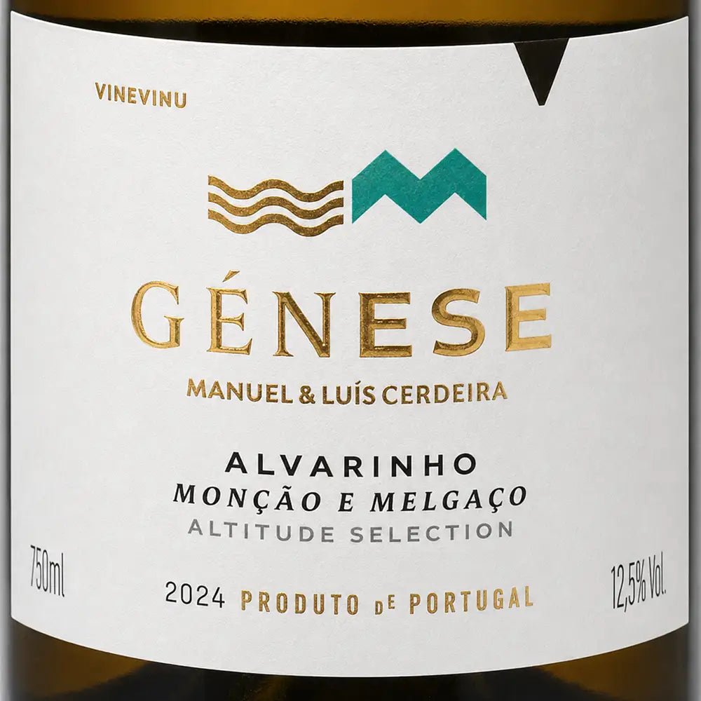 Close-up of a wine label reading GÉNESE with gold and teal logo elements on a white label, with dark brown bottle edges visible at the top and bottom.