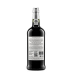 A bottle of Cálem Velhotes 10 years Port wine shown from the back, featuring a dark glass body, a silver foil seal, and a white product information label with text and a barcode.