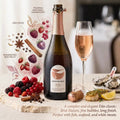 Bottle of Monterinhos wine with a glass of rose wine, surrounded by fruits and oysters on a stone surface.
