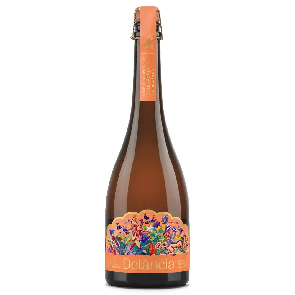 A bottle of Delância Orange with a vibrant, multicolored floral label and an orange neck foil, shown on a solid white background.