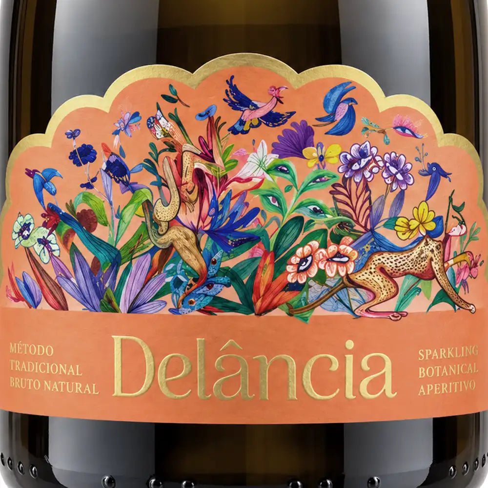 Close-up of a Delância sparkling wine bottle label featuring a vibrant, detailed botanical and animal illustration on an orange background with gold lettering.