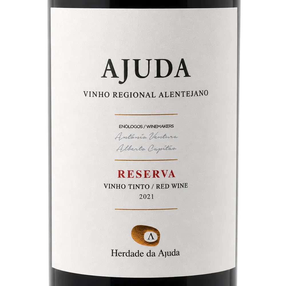 A close-up of a wine bottle label reading AJUDA Reserva Vinho Tinto Red Wine 2021, with a white label, black text, and a small gold seal on a dark bottle background.