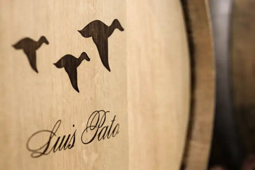 Wooden barrel with 'Luis Pato' branding and three black bird silhouettes.