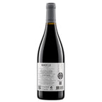 A bottle of Manoella Douro red wine with a dark glass body, gray foil capsule, and a white label showing the back details, set against a plain white background.